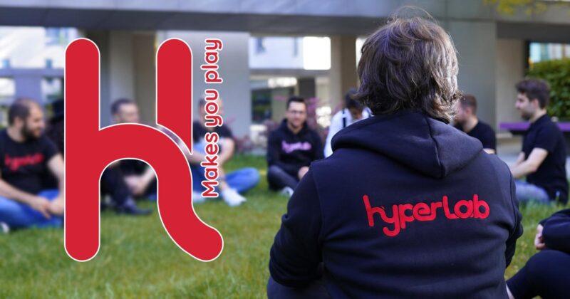 Hyperlab Games Studio workers sitting on a grass field